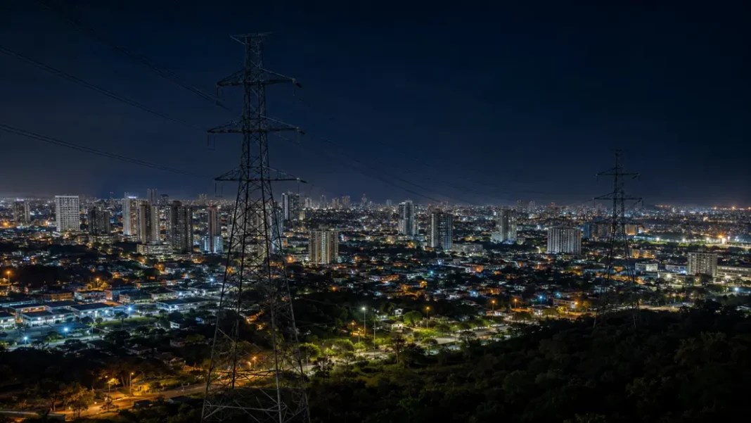 Torres de transmisión eléctrica sobre una ciudad de la Región Caribe durante la noche